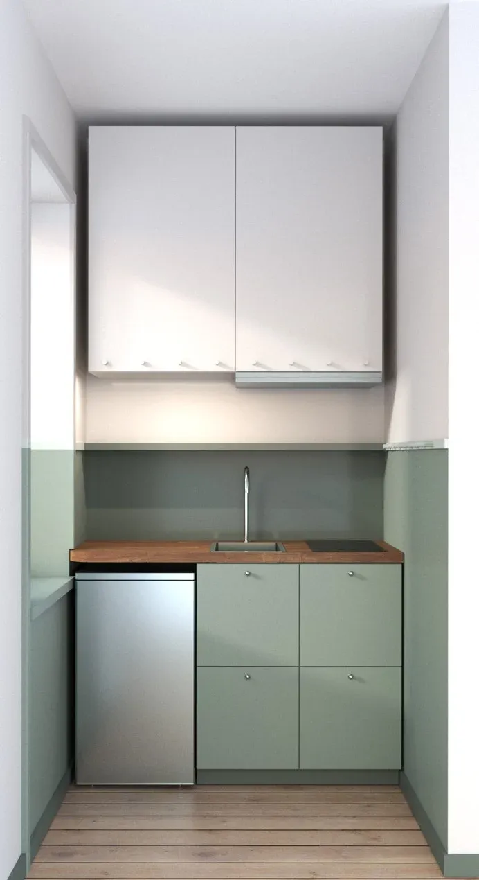 Kök i 26 kvadratmeters lägenhet med gröna köksluckor och valnötsbänkskiva